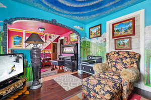 Sitting room with hardwood / wood-style flooring