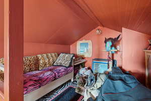 Garage Area: Bedroom featuring lofted ceiling