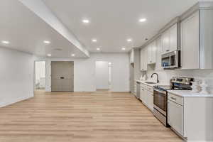 Kitchenette featuring sink, stainless steel appliances