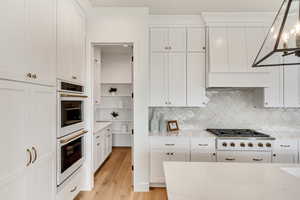 Kitchen featuring white cabinetry and light quartz countertops