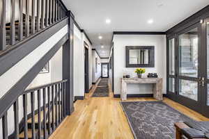 Hall featuring french doors and light hardwood / wood-style flooring