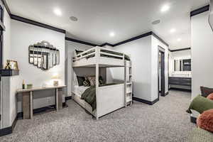 Bedroom with crown molding and carpet floors