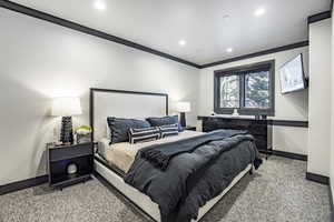 Bedroom featuring crown molding and carpet floors