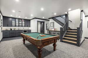 Rec room with pool table, bar, carpet flooring, and ornamental molding