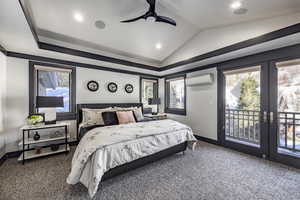 Carpeted bedroom with french doors, vaulted ceiling, access to outside, an AC wall unit, and ceiling fan