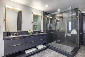 Bathroom with vanity, a textured ceiling, and walk in shower