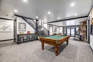 Game room with french doors, pool table, ornamental molding, and carpet