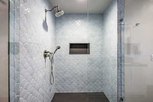 Bathroom featuring a tile shower