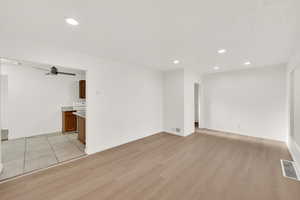 Empty room featuring ceiling fan and light wood-type flooring