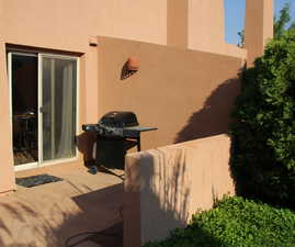 View of patio with a grill