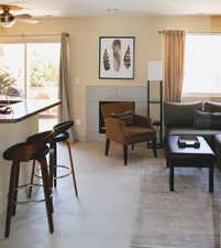 Living room featuring a healthy amount of sunlight and ceiling fan