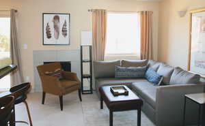 Tiled living room featuring plenty of natural light