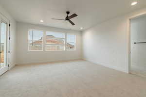 Empty room with light carpet and ceiling fan