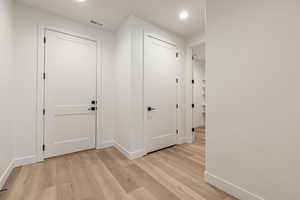 Hallway with light wood-type flooring