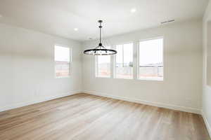 Spare room with plenty of natural light and light wood-type flooring