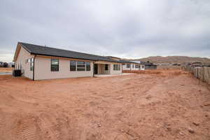 Rear view of property featuring a patio, a mountain view, and central air condition unit