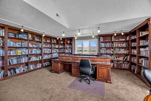 Carpeted office space featuring a textured ceiling