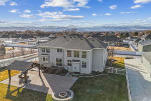 View of front of home with a mountain view and a front yard