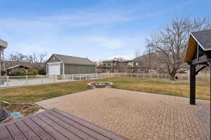 Deck with a yard, a patio, and an outdoor fire pit