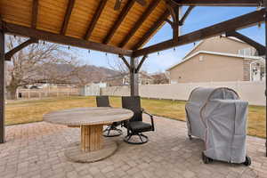 View of patio / terrace featuring a shed, a grill, and a gazebo