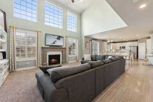 Living room with ceiling fan and light wood-type flooring