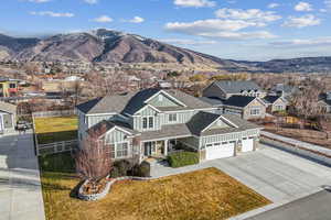 Exterior space with a mountain view, a garage, and a front yard