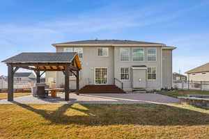 Rear view of house featuring a patio area and a lawn