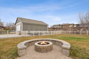 View of patio / terrace with a garage and a fire pit