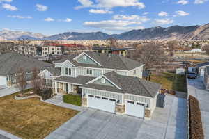 View of front of home featuring a mountain view and a front lawn