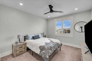 Bedroom featuring ceiling fan and carpet