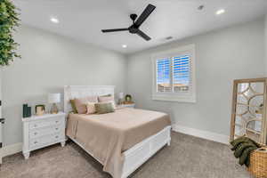 Carpeted bedroom with ceiling fan