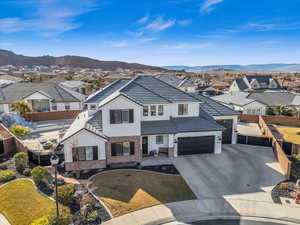 View of front of home with a mountain view and a front yard