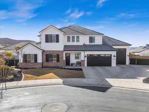 View of front of house with a mountain view and a garage