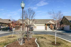 Ranch-style home with a garage and a front yard