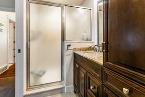 Bathroom with vanity, tile patterned floors, and walk in shower