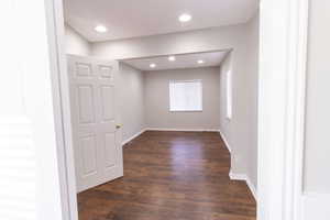 Unfurnished room with dark hardwood / wood-style flooring