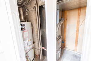 Utility room featuring water heater