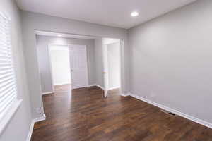 Unfurnished room with dark hardwood / wood-style floors