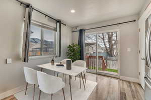 Dining area featuring a mountain view and light wood-type flooring