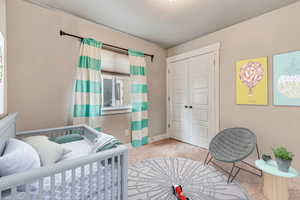 Carpeted bedroom with a closet