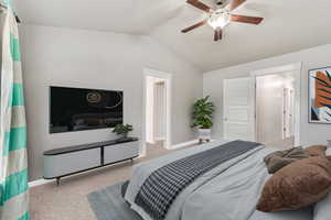 Bedroom with lofted ceiling, light carpet, and ceiling fan