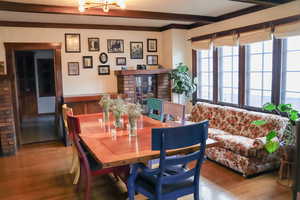 Dining area featuring beam ceiling and hardwood  floors