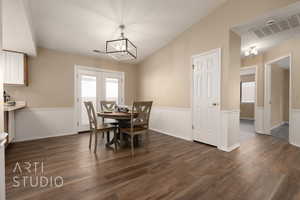 Dining area featuring dark hardwood / wood-style floors and a notable chandelier