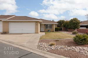 Ranch-style house featuring a garage and a front lawn