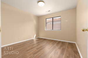 Spare room with hardwood / wood-style flooring