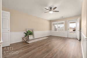 Spare room featuring hardwood / wood-style flooring, vaulted ceiling, and ceiling fan