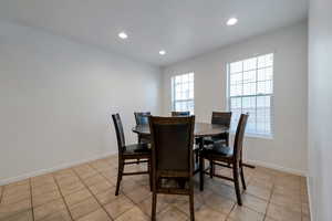 Dining area with light tile patterned flooring