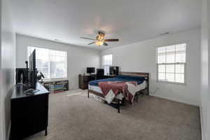 Bedroom featuring ceiling fan and light carpet