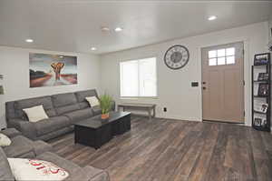 Living room with dark wood-type flooring