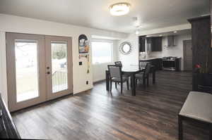 Dining space featuring french doors, dark hardwood / wood-style floors, and sink